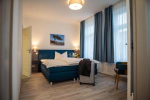 Postel nebo postele na pokoji v ubytování Hotel Hanseat Stralsund