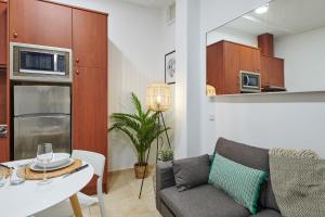 a living room with a couch and a table at LEEWAYS APARTMENT in GRAN VÍA XIV in Madrid