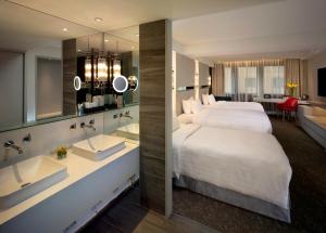 a hotel room with a large bed and a large mirror at Nathan Hotel in Hong Kong