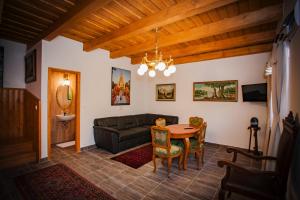 a living room with a couch and a table at Grabensia Fogadó in Garáb