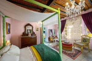 a bedroom with a canopy bed and a mirror at Tina's Country Home in Askas