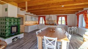 a large kitchen with a wooden table and chairs at chalupa Kristina u Adršpachu in Teplice nad Metují