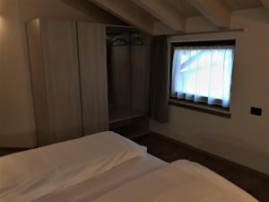 Posteľ alebo postele v izbe v ubytovaní MOUNTAIN RESORT Appartamenti