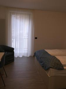 Posteľ alebo postele v izbe v ubytovaní MOUNTAIN RESORT Appartamenti