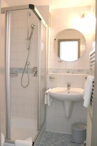a bathroom with a shower and a sink at Hotel An der Linde in Neckarsulm