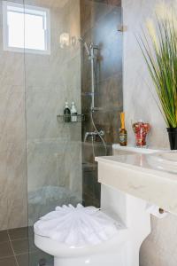 a bathroom with a shower and a toilet and a sink at The Peak Pool Villa in Krabi town