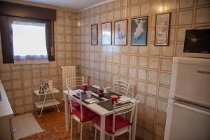 a kitchen with a table and chairs and a refrigerator at Ca' Bianca Relax Apartment in Venice-Lido