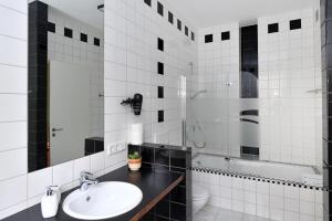 a bathroom with a sink and a toilet at Apartment Nürnberg Like Home in Nürnberg +21 photos