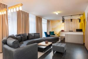 a living room with a couch and a table at ibis Styles Dresden Neustadt in Dresden