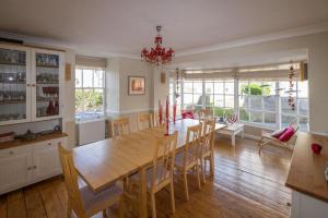 a dining room with a wooden table and chairs at Trethoway in Port Isaac