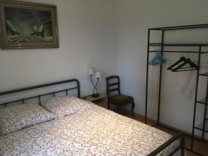 a bedroom with a bed and a picture on the wall at LA POMMERAIE in Bosc-Bénard-Commin