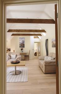 a living room with two couches and a table at Heron's Hideaway in Wells next the Sea