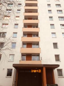 a tall apartment building with a door in front of it at Cozy Home Apartment Lielvardes, free parking, self check-in in Rīga