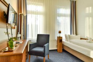 Postel nebo postele na pokoji v ubytování Hotel am Fischerstrand