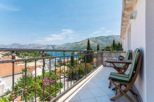 a balcony with a view of the ocean and mountains at Apartments Dadic in Cavtat