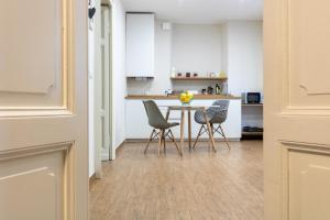 a kitchen with a table and chairs in a room at aqualago casa vacanze apartment E in Verbania