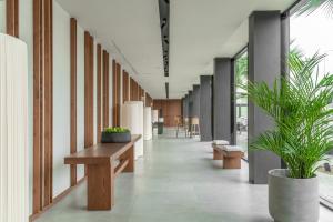 a hallway with benches and potted plants in a building at Hotel Verde Mar & SPA in Ribeira Grande