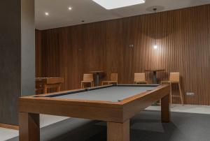 a pool table in a room with chairs at Hotel Verde Mar & SPA in Ribeira Grande