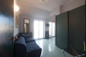 a room with a couch in the middle of a room at Hotel Tirreno in Genoa