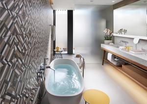 a bathroom with a tub and a sink at Mandarin Oriental, Barcelona in Barcelona