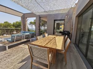 a dining room with a table and chairs on a patio at Casa de la Luz in Sa-Riera