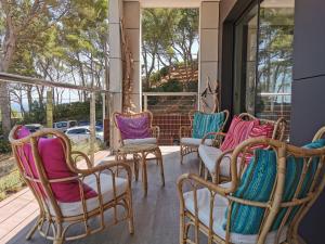 a group of chairs sitting on a porch at Casa de la Luz in Sa-Riera