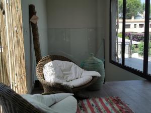 a wicker chair sitting in a room with a mirror at Casa de la Luz in Sa-Riera +36 photos