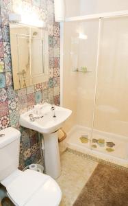 a bathroom with a toilet and a sink and a shower at Avarest House Bed and Breakfast in Portrush