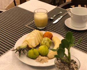 a plate of food on a table with a glass of orange juice at Hotel Ida Inés in Frontera