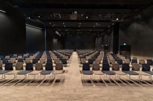 an empty room with chairs and a stage at Quality Hotel River Station in Drammen