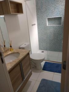 a bathroom with a sink and a toilet and a shower at Apto em santos 900 m praia in Santos