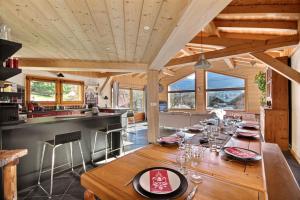 - une cuisine et une salle à manger avec une table et des verres dans l'établissement CHALET INDIVIDUEL -SAUNA - WIFI- SAINT JEAN D'AULPS - 14 PERSONNES - CHALET COFFY, à Saint-Jean-dʼAulps 16 autres photos