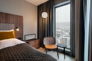 a hotel room with a bed and a large window at Quality Hotel River Station in Drammen +71 photos