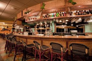 a bar with a bunch of chairs around it at Holiday Inn & Suites Clearwater Beach, an IHG Hotel in Clearwater Beach