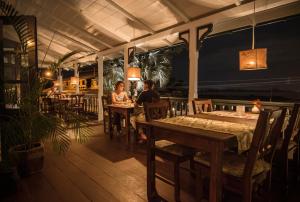 two people sitting at tables in a restaurant at Boutique Hotel Peperpot in Meerzorg