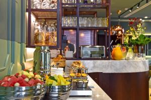 a kitchen with a counter with fruit in buckets at My Story Hotel Augusta in Lisbon