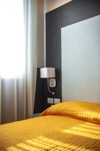 Postel nebo postele na pokoji v ubytování Hotel Astoria
