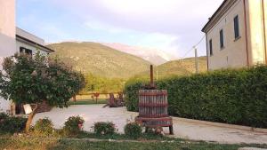 a garden with a bench in front of a building at Masseria La Rocca in Pacentro