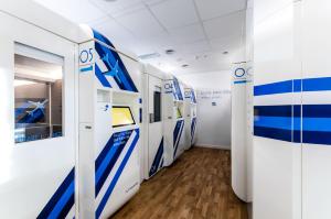a room with blue and white signs on the walls at Resting Pods - ZzzleepandGo Modlin Airport WMI in Nowy Dwór Mazowiecki
