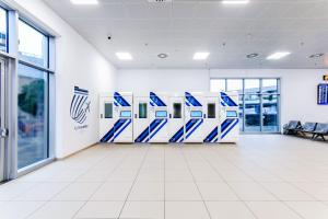 a row of blue and white refrigerators in a building at Resting Pods - ZzzleepandGo VCE Venice Airport in Tessera