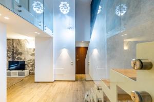 a hallway with a staircase and a living room at Palermo Blu - Palazzo Quaroni in Palermo