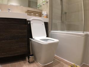 a bathroom with a white toilet and a shower at Victoria Street Apartments in St. Albans