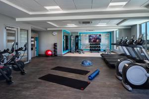 a gym with treadmills and exercise equipment in a room at Crowne Plaza - North Augusta, an IHG Hotel in North Augusta