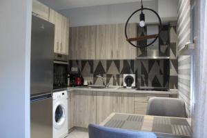 a kitchen with a washer and a sink and a dishwasher at Presidential Palace 1 in Drama