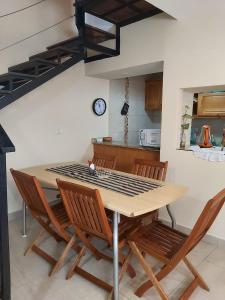 a dining room table with chairs and a clock on the wall at Taruca Apart in Salta +52 photos