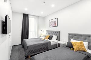a bedroom with a bed and a couch at Kaunas Garden in Kaunas