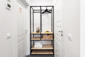 a walk in closet with a mirror and a door at Kaunas Garden in Kaunas +137 photos