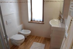 a bathroom with a toilet and a sink at B&B SEGONZANO in Segonzano