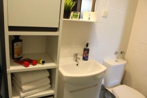 a bathroom with a sink and a toilet and towels at Hotel39 in Plovdiv