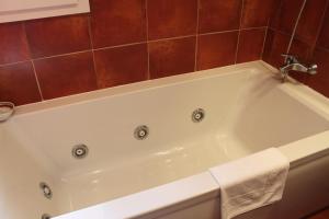 a white bath tub in a bathroom at Hotel Picasso in Torroella de Montgrí
